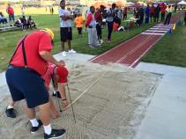 Officials re-measure Zakiyy Williams' meet-record 47-4 1/2 in the triple jump Friday.